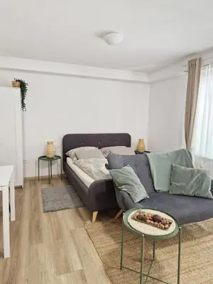 a living room with a couch and a bed at Apartments Bassanese in Bled