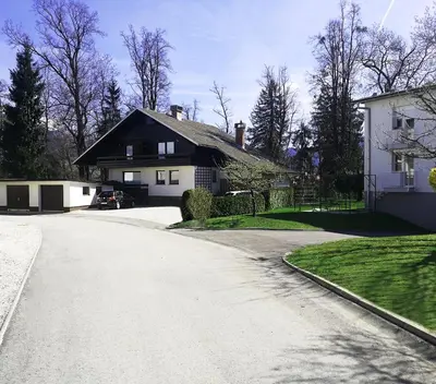 a house on a street with a driveway at Apartments Bassanese in Bled