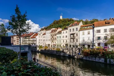 a group of buildings next to a river at The Muse' Hideaway in Ljubljana
