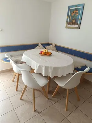 a table with chairs and a plate of fruit on it at Hiška na gorci in Podčetrtek