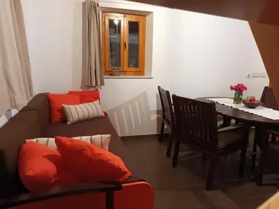 a living room with a couch and a table at Sweet Country House in Markovci