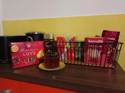 a shelf with books and a cup of coffee and a basket of books at Sweet Country House in Markovci