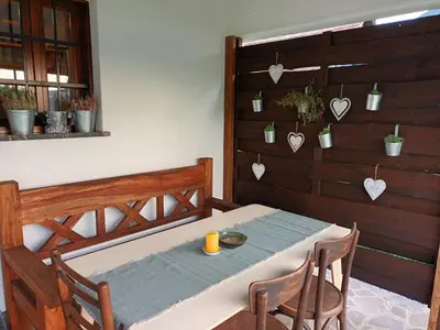 a table and two chairs in a room with a table and a table at Sweet Country House in Markovci