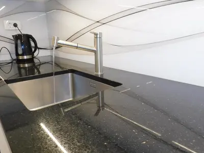 a kitchen with a sink in a room at Modern Apartment Hrenova Street in Ljubljana