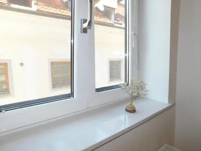 a window with a vase on a white window sill at Modern Apartment Hrenova Street in Ljubljana