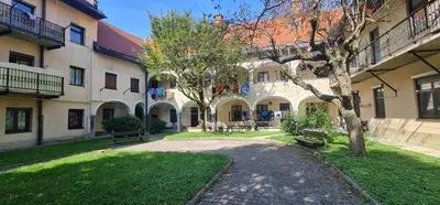 a courtyard with two benches in front of a building at Modern Apartment Hrenova Street in Ljubljana