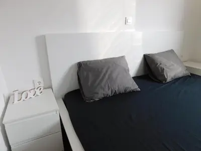 a small room with a bed with two pillows on it at Elegant Apartment Poklukarjeva Street in Ljubljana