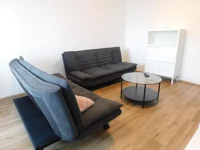 a living room with a couch and a table at Elegant Apartment Poklukarjeva Street in Ljubljana