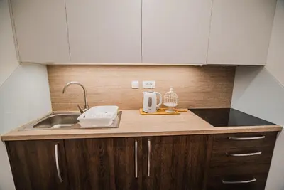 a kitchen counter top with a sink and aounter at Studio Mobile Home Gotar in Kobarid