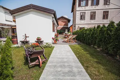 a garden with a walkway in front of a house at Studio Mobile Home Gotar in Kobarid