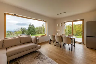 a living room with a couch and a table with chairs at Styria Estate, near Terme Olimia Spa Resort in Podplat