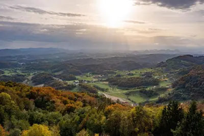 a view of a valley in the mountains with the sun shining at Styria Estate, near Terme Olimia Spa Resort in Podplat