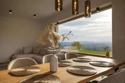 a dining room with a table and a large window at Styria Estate, near Terme Olimia Spa Resort in Podplat