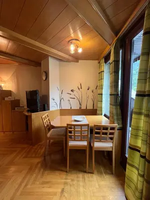 a dining room with a table and chairs at Little King - Feel like at home in Kranjska Gora