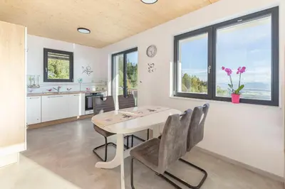 a kitchen and dining room with a table and chairs at Apartments Nikolaj in Preddvor