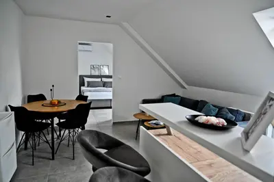 a kitchen and living room with a table and chairs at Apartment Lilly in Slivnica pri Mariboru