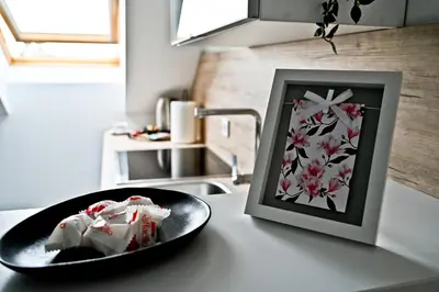 a plate of food on a counter next to a picture at Apartment Lilly in Slivnica pri Mariboru