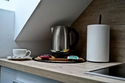 a coffee pot on a counter next to a roll of paper towels at Apartment Lilly in Slivnica pri Mariboru