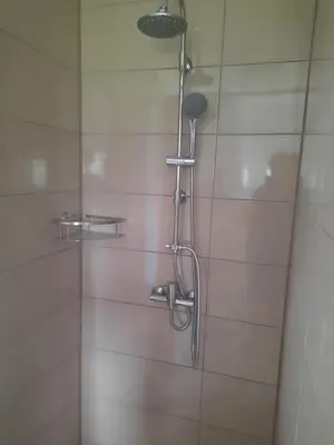 a shower with a shower head in a bathroom at Apartma Ob jezeru in Gradišče v Slovenskih Goricah