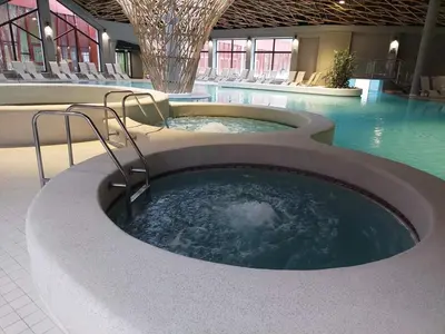 a hot tub in the middle of a swimming pool at F96 TERME OLIMIA, Aqualuna KAMP NATURA PODČETRTEK card included all year in Podčetrtek
