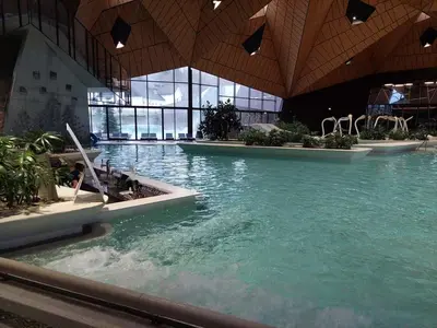 a large pool of water in a building at F96 TERME OLIMIA, Aqualuna KAMP NATURA PODČETRTEK card included all year in Podčetrtek