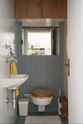 a bathroom with a toilet and a sink and a mirror at Family apartment in the city centre - FREE parking garage in Ljubljana