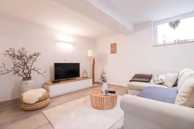 a living room with a couch and a tv at Apartment below Eden in Bled