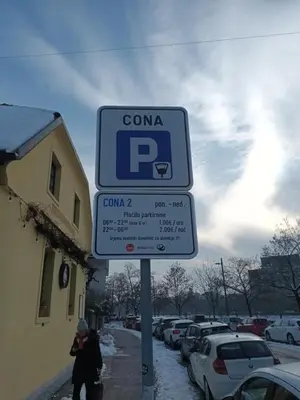 a parking sign on the side of a street at House Trta in Ljubljana