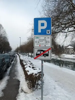 a street sign in the snow with a parking lot at House Trta in Ljubljana