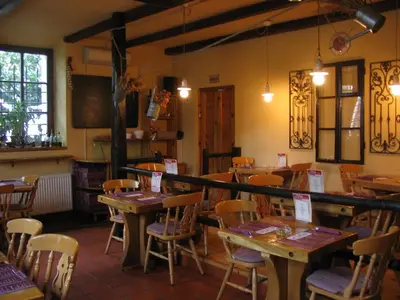 a dining room with wooden tables and chairs at House Trta in Ljubljana