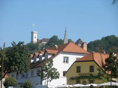 a white building with a red roof at House Trta in Ljubljana