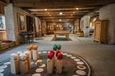 a room with a group of bowling pins and a table at Country House Trata in Kranjska Gora