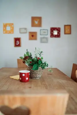 a table with a plant and a cup on it at Country House Trata in Kranjska Gora