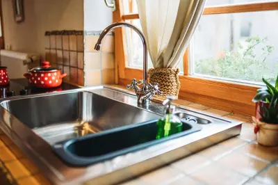 a sink in a kitchen with a window at Country House Trata in Kranjska Gora