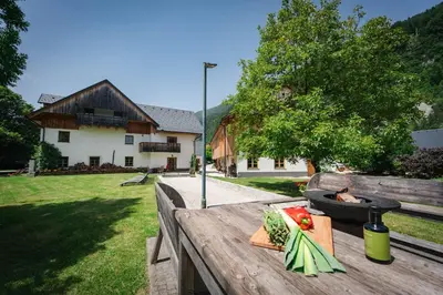 a wooden table with a plate of vegetables on it at Country House Trata in Kranjska Gora