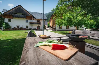 a wooden table with a cutting board with vegetables on it at Country House Trata in Kranjska Gora