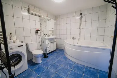 a bathroom with a tub and a toilet and a sink at Holiday Home Aleks in Lendava