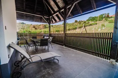a balcony with a table and chairs and a view at Holiday Home Aleks in Lendava