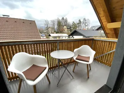 two chairs and a table on a balcony at BLED LAKE HOUSE - Apartment SKY in Bled