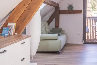 a living room with a couch in the attic at BLED LAKE HOUSE - Apartment SKY in Bled