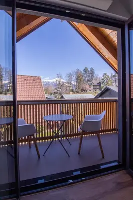 a patio with two chairs and a table on a balcony at BLED LAKE HOUSE - Apartment SKY in Bled