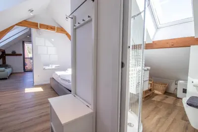 a bathroom with a glass shower and a bedroom at BLED LAKE HOUSE - Apartment SKY in Bled