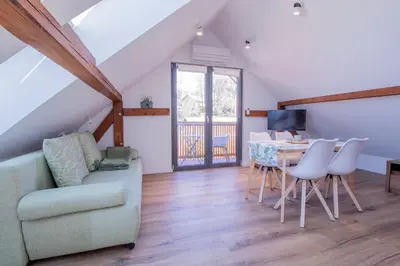 a living room with a couch and a table at BLED LAKE HOUSE - Apartment SKY in Bled