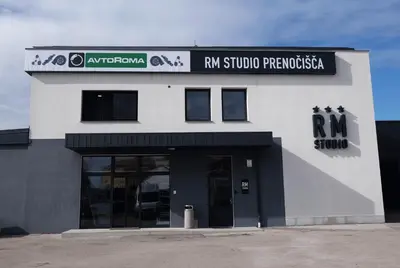 a building with a sign that reads rm studio provocateurs at RM Roma Studio in Celje