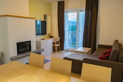 a living room with a couch and a tv at Apartmajska hiša Breza in Ribnica na Pohorju