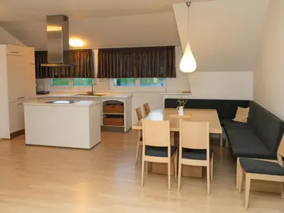 a kitchen and dining room with a table and chairs at Apartmajska hiša Breza in Ribnica na Pohorju