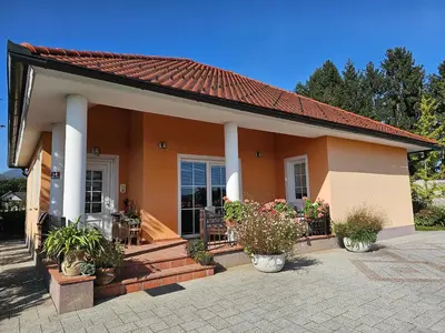 a small house with a porch with potted plants at apartment AURORA in Rogaška Slatina
