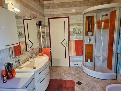 a bathroom with two sinks and a shower and a tub at apartment AURORA in Rogaška Slatina