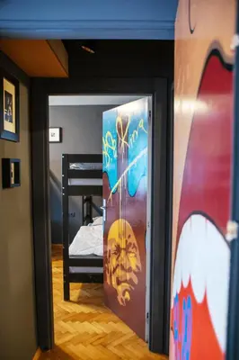 a door in a room with a bunk bed at Sax Pub Hostel Ljubljana in Ljubljana