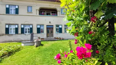 a house with pink flowers in front of it at Vila Jasna in Radovljica